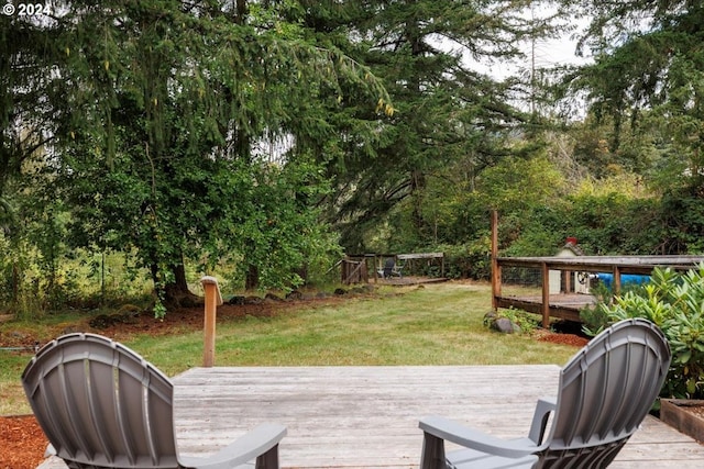 wooden deck with a lawn