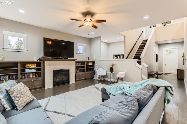 living room featuring ceiling fan and dark wood-type flooring