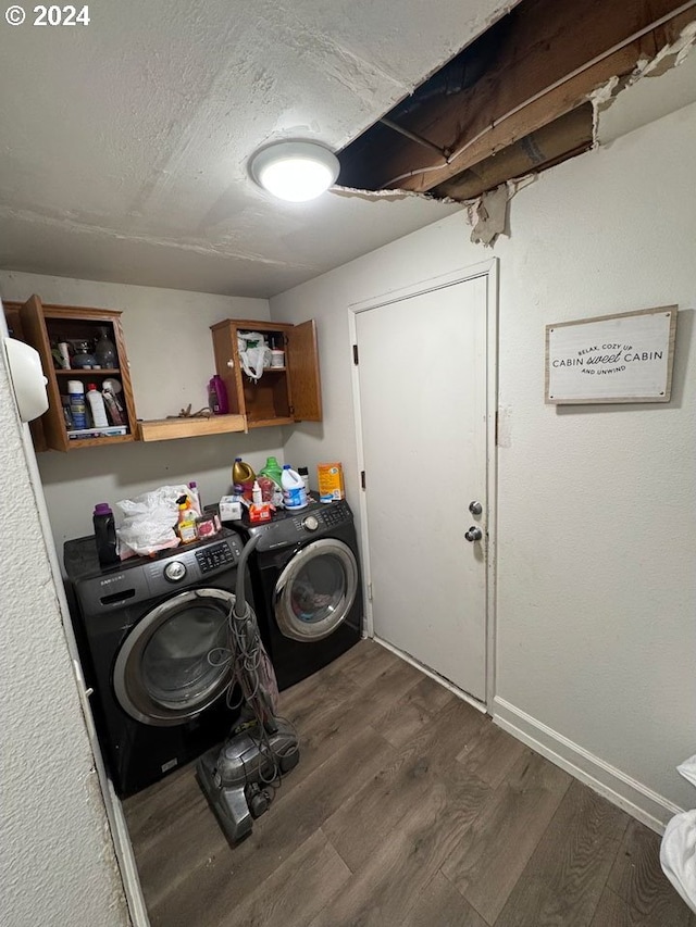 laundry area with cabinets, dark hardwood / wood-style flooring, washer and dryer, and a textured ceiling