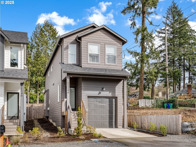 view of front of house featuring roof with shingles, fence, an attached garage, and concrete driveway