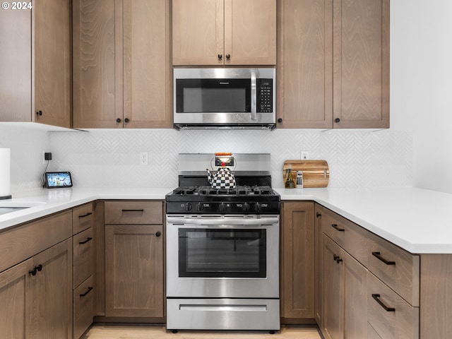 kitchen with backsplash and stainless steel appliances