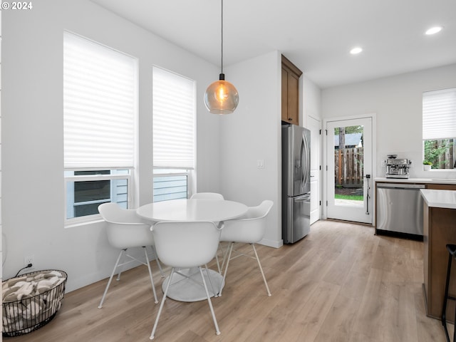 dining area featuring light wood-style floors, baseboards, and recessed lighting