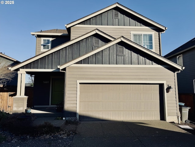 view of front facade featuring board and batten siding, driveway, and a garage