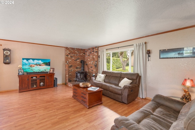 living room featuring a wood stove, a textured ceiling, light wood-type flooring, and crown molding