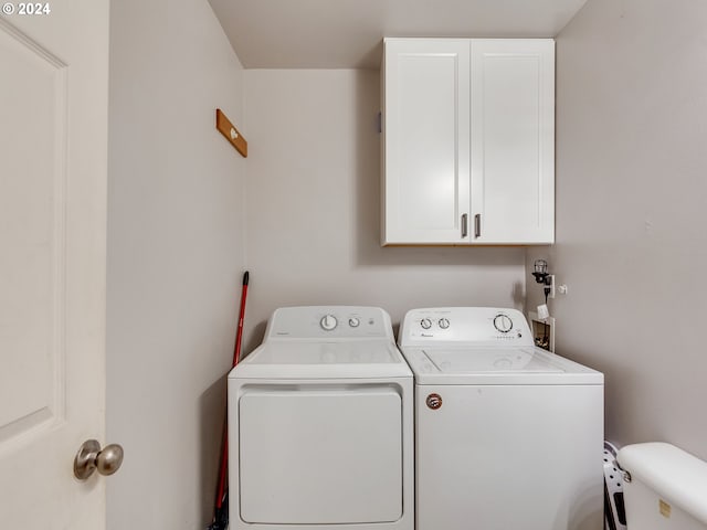 washroom featuring independent washer and dryer and cabinets