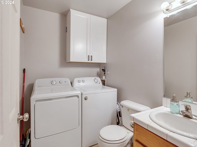 bathroom with vanity, independent washer and dryer, and toilet