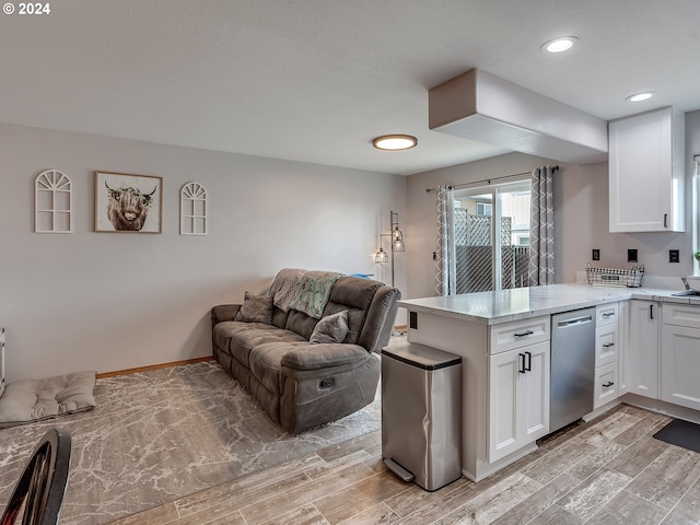 kitchen with kitchen peninsula, light hardwood / wood-style floors, white cabinets, and stainless steel dishwasher