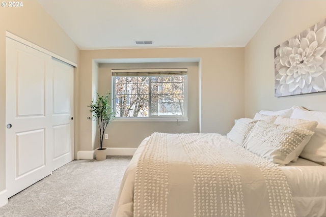 bedroom featuring carpet flooring, a closet, and vaulted ceiling