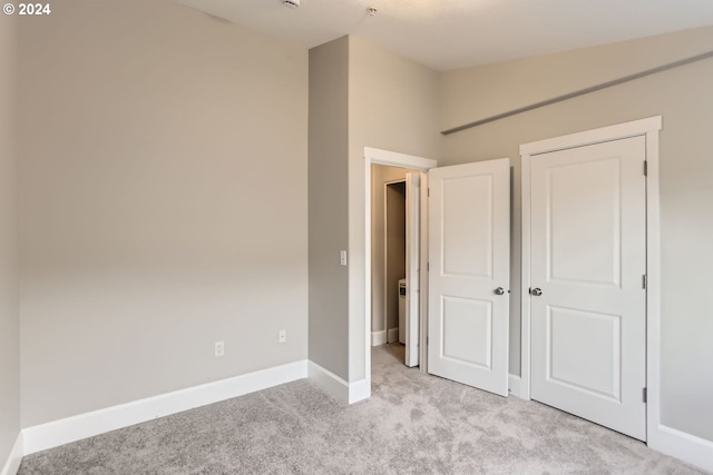 unfurnished bedroom with light carpet