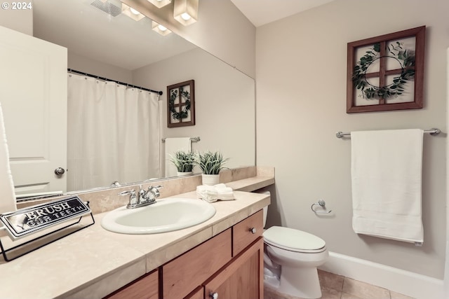 bathroom with tile patterned floors, vanity, and toilet