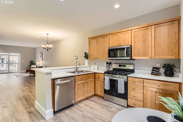 kitchen with light hardwood / wood-style floors, kitchen peninsula, sink, and appliances with stainless steel finishes