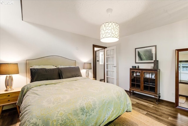 bedroom with hardwood / wood-style flooring