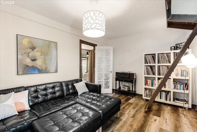 living room with a textured ceiling and hardwood / wood-style floors