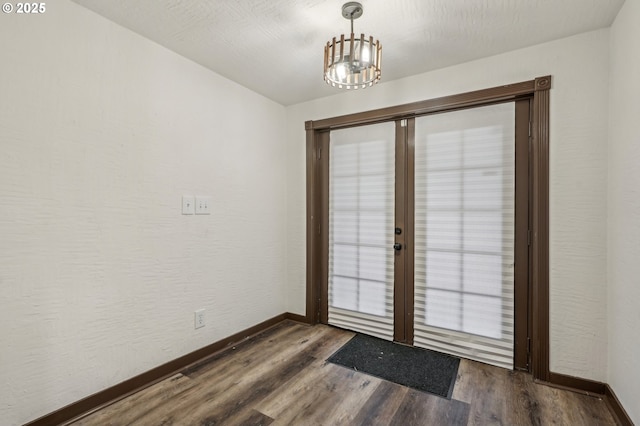 doorway with french doors and dark hardwood / wood-style floors