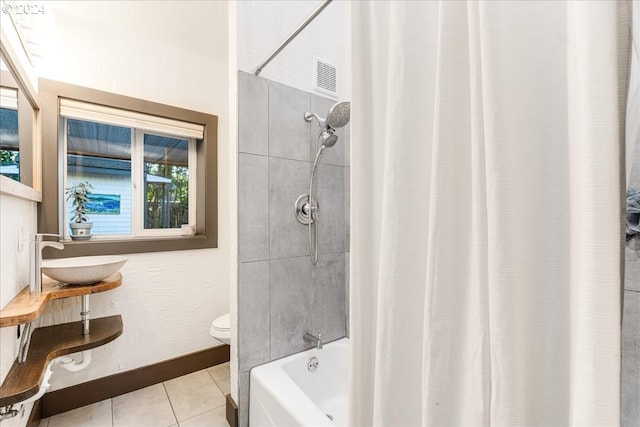 full bathroom with toilet, tile patterned flooring, sink, and shower / tub combo with curtain