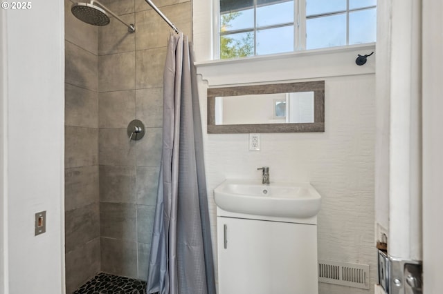 bathroom featuring vanity and curtained shower