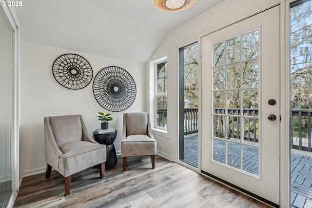 sitting room featuring vaulted ceiling and light hardwood / wood-style flooring