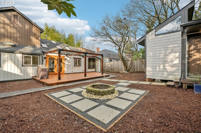 view of patio with a wooden deck and an outdoor fire pit