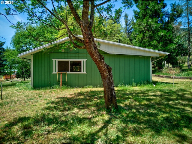 view of side of home with a yard