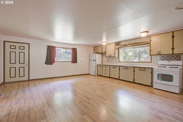 kitchen featuring light hardwood / wood-style floors, white appliances, and a healthy amount of sunlight