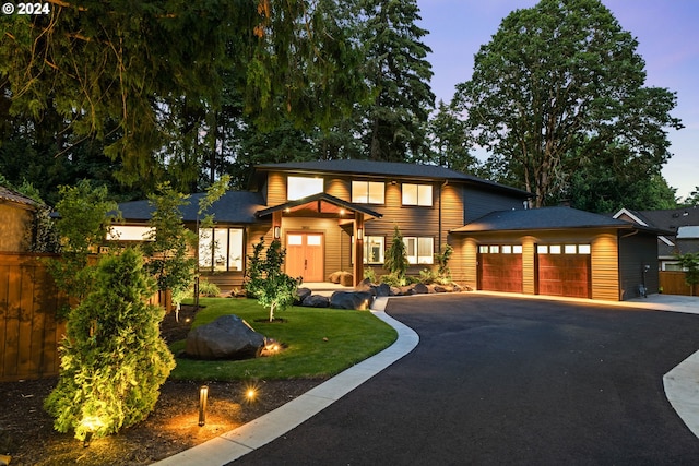 view of front facade featuring a garage and a yard