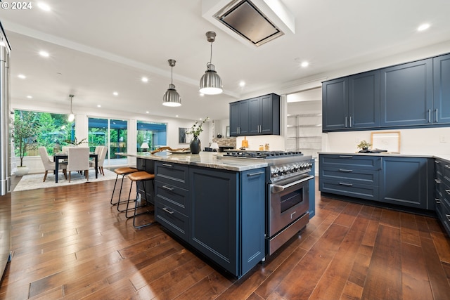 kitchen with stainless steel range, pendant lighting, a kitchen island, and blue cabinetry