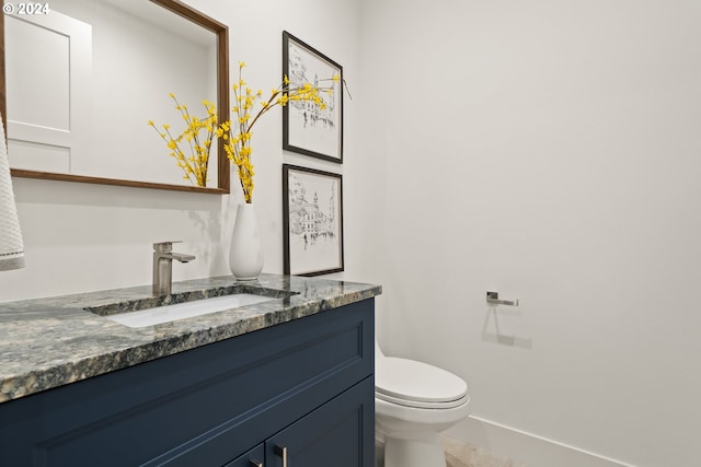 bathroom with tile patterned floors, vanity, and toilet