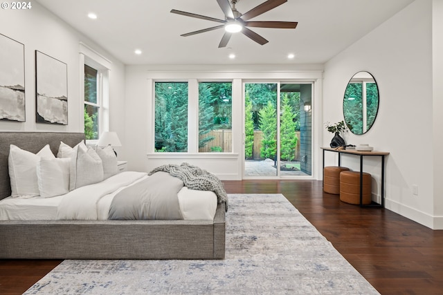 bedroom featuring access to exterior, ceiling fan, dark hardwood / wood-style flooring, and multiple windows