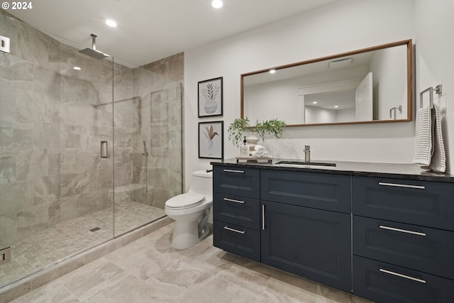 bathroom with vanity, toilet, and a shower with shower door