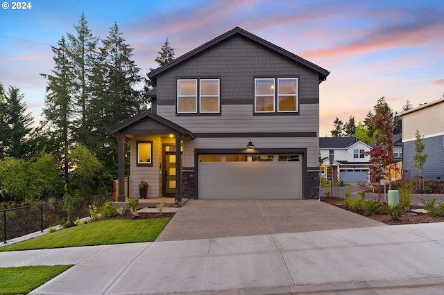 view of front of house with a garage and a yard