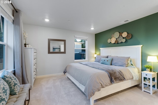 bedroom featuring light colored carpet