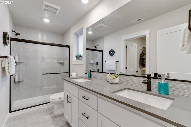 bathroom with walk in shower, vanity, toilet, and tile patterned flooring