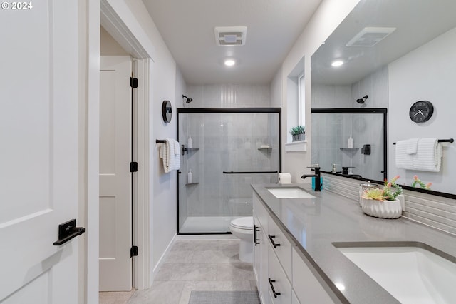 bathroom featuring walk in shower, vanity, and toilet