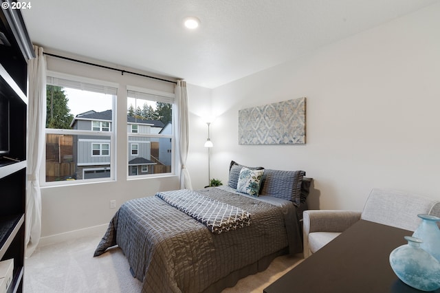 bedroom featuring light carpet