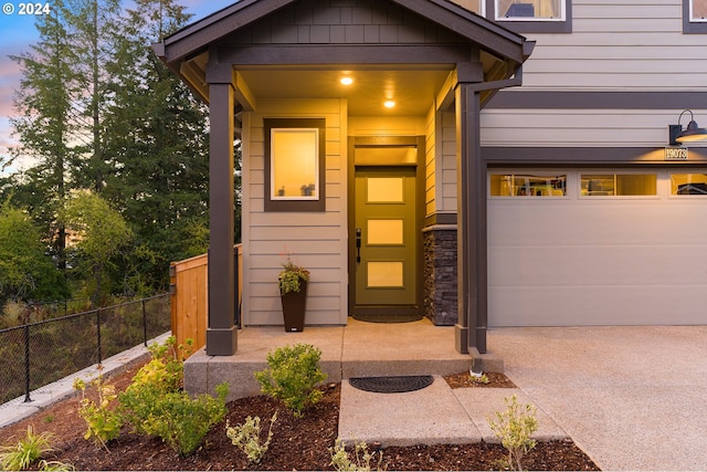 exterior entry at dusk with a garage