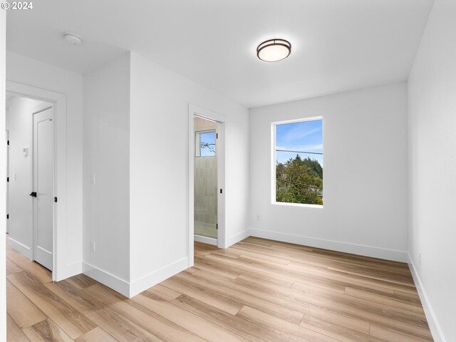 758 NE 91st Ave Unit 1, Portland, OR 97220 - empty room featuring baseboards and light wood-style flooring