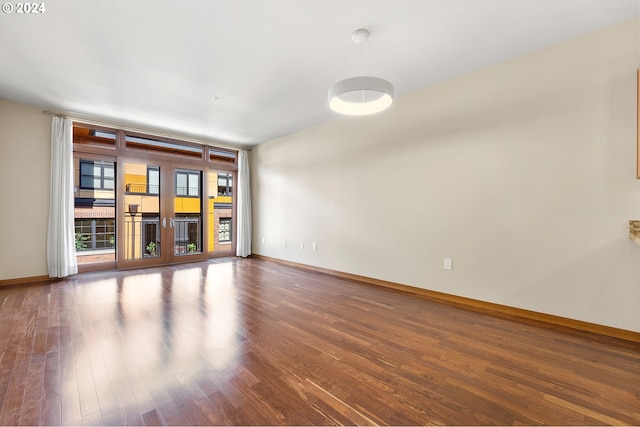 empty room with french doors and dark wood-type flooring