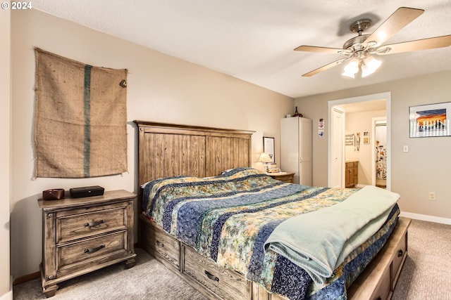 bedroom with ceiling fan, ensuite bath, and carpet