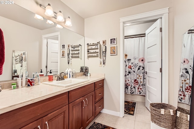 bathroom with curtained shower, vanity, and tile patterned floors