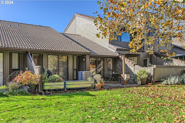 back of house featuring a patio, central AC, and a lawn