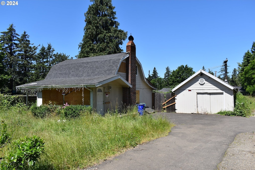 view of home's exterior featuring an outbuilding