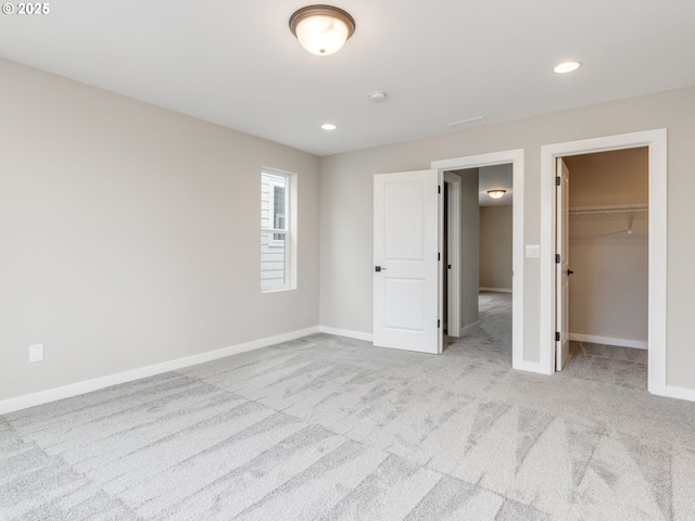 838 NW 178th Way, Ridgefield, WA 98642 - unfurnished bedroom with carpet flooring, a walk in closet, baseboards, recessed lighting, and a closet