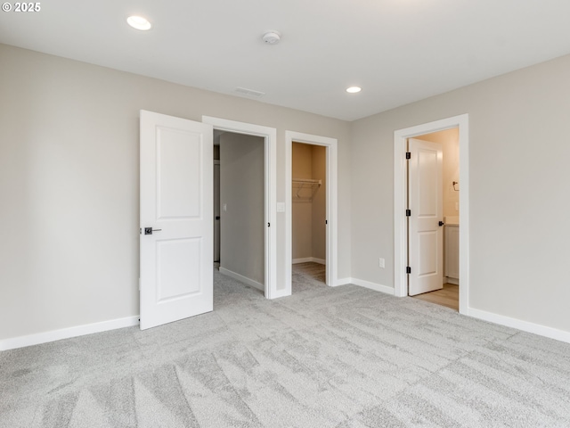 838 NW 178th Way, Ridgefield, WA 98642 - unfurnished bedroom with carpet, a walk in closet, baseboards, recessed lighting, and a closet