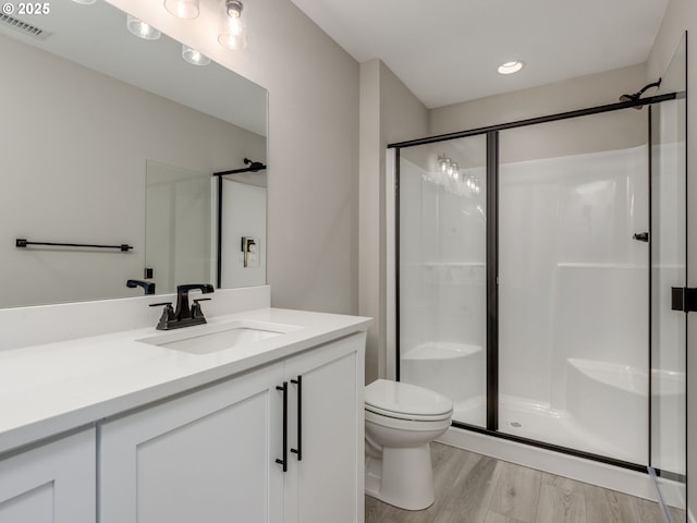 838 NW 178th Way, Ridgefield, WA 98642 - bathroom featuring a shower stall, toilet, vanity, wood finished floors, and recessed lighting