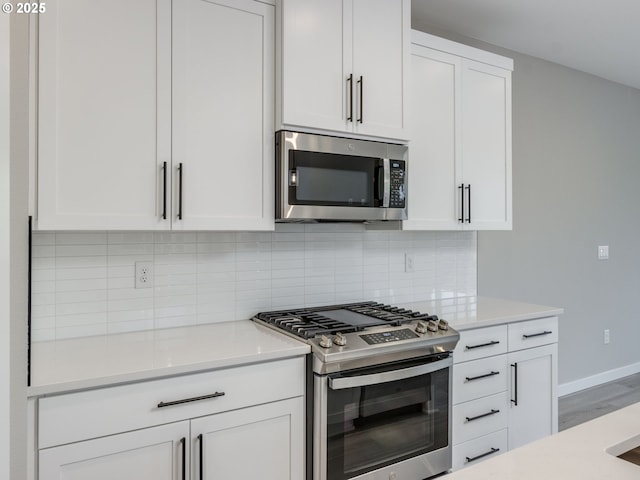 838 NW 178th Way, Ridgefield, WA 98642 - kitchen with appliances with stainless steel finishes, light countertops, decorative backsplash, and white cabinets
