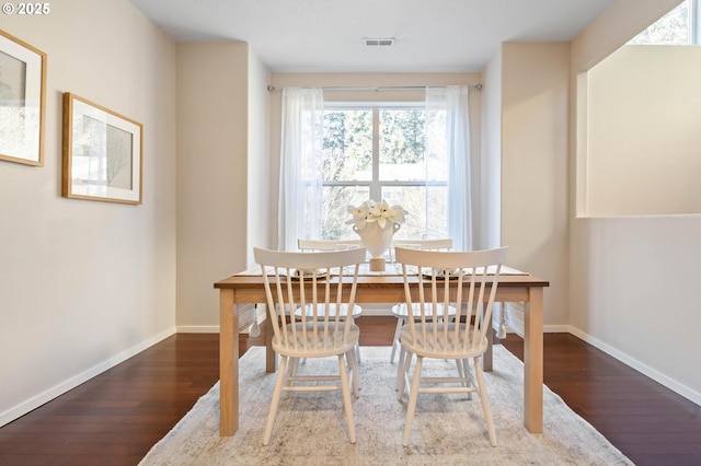 dining area featuring dark hardwood / wood-style flooring