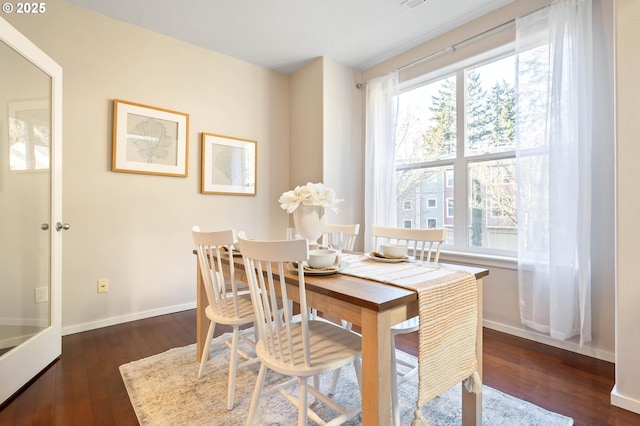 dining area with dark hardwood / wood-style flooring