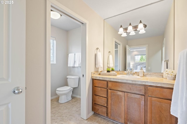 bathroom with vanity, a wealth of natural light, and toilet