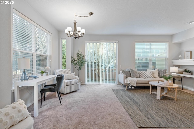 living room featuring a chandelier, carpet floors, and a textured ceiling