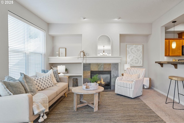 living room featuring a tile fireplace and carpet floors